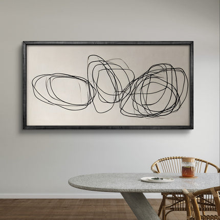 Abstract wall art with black lines on a beige background in a dining room setting.